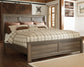 Juararo King Panel Bed with Mirrored Dresser, Chest and Nightstand Smyrna Furniture Outlet